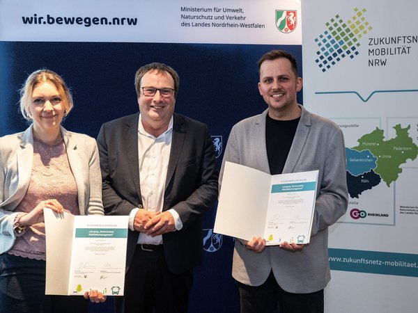 NRW-Verkehrsminister Oliver Krischer (mitte) überreichte Vera Mölders und Raphael Jolly vom Märkischen Kreis die Urkunden zur erfolgreichen Qualifizierung zur Mobilitätsmanagerin bzw. Mobilitätsmanager. Foto: MUNV NRW/Caroline Seidel